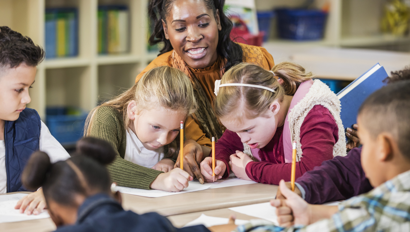 A Teacher Works With Students in an Inclusive Classroom.