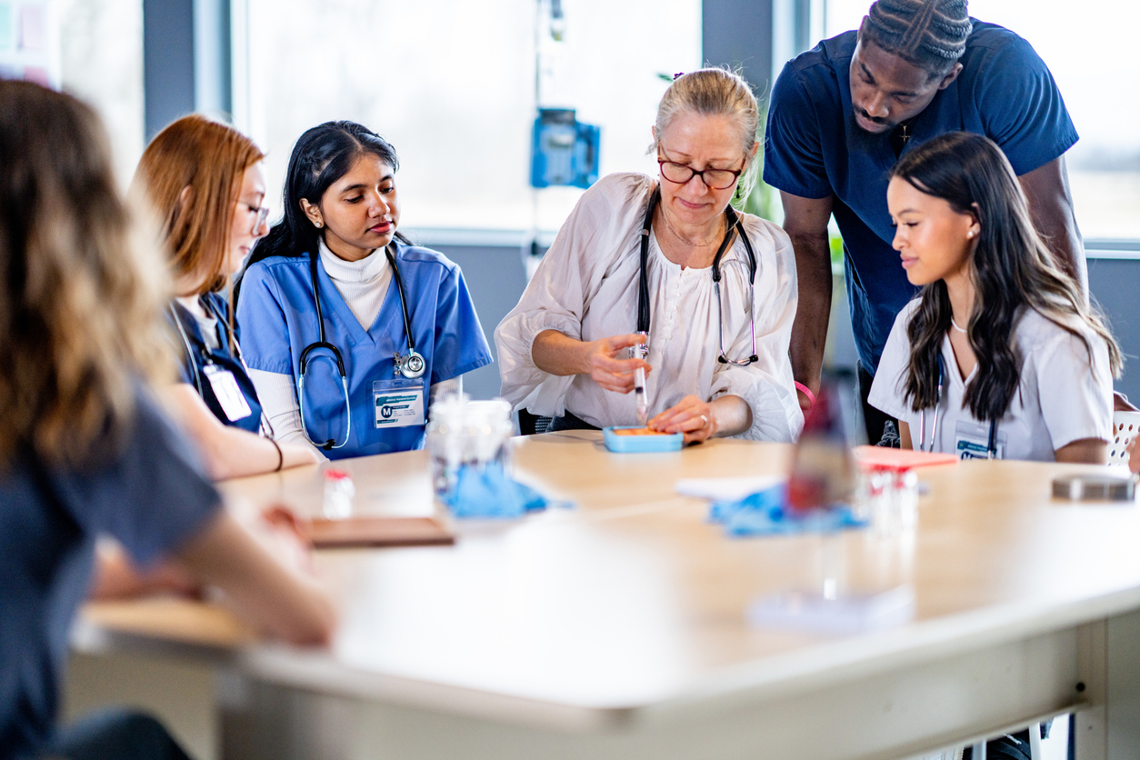 A Nurse Educator Shows a Group of Student Nurses How to Analyze a Blood Sample..jpg