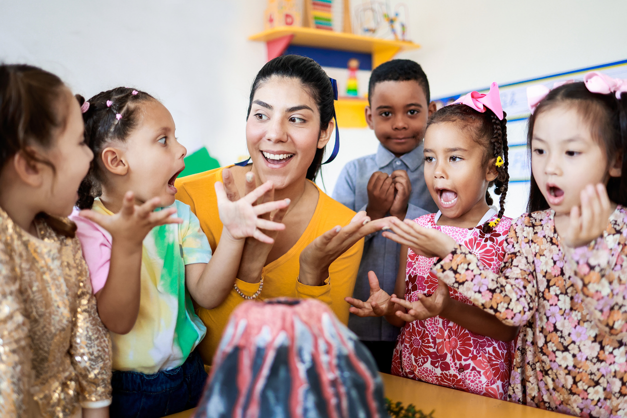 A Preschool Teacher Shows a Group of Students a Model Volcano..jpg