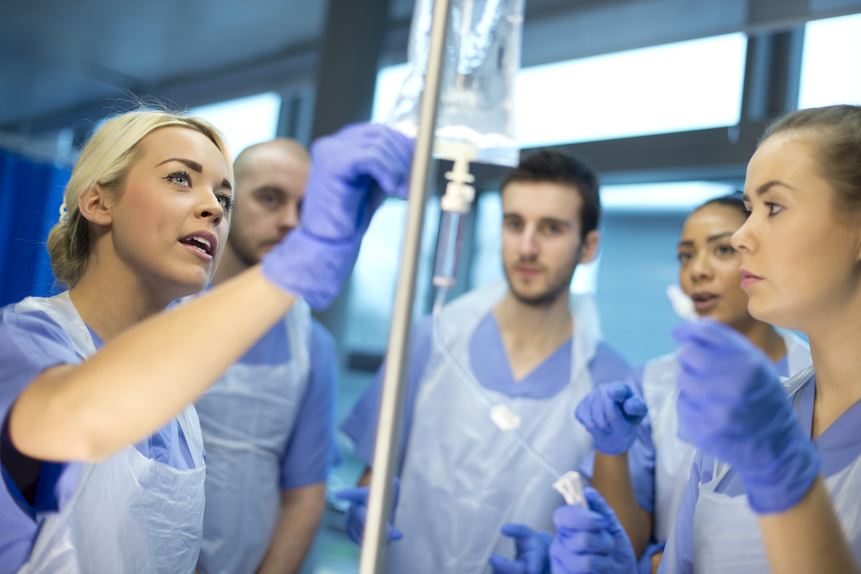 A Clinical Nurse Leader Shows a Group of Beginning Nurses How to Insert an Iv..jpg