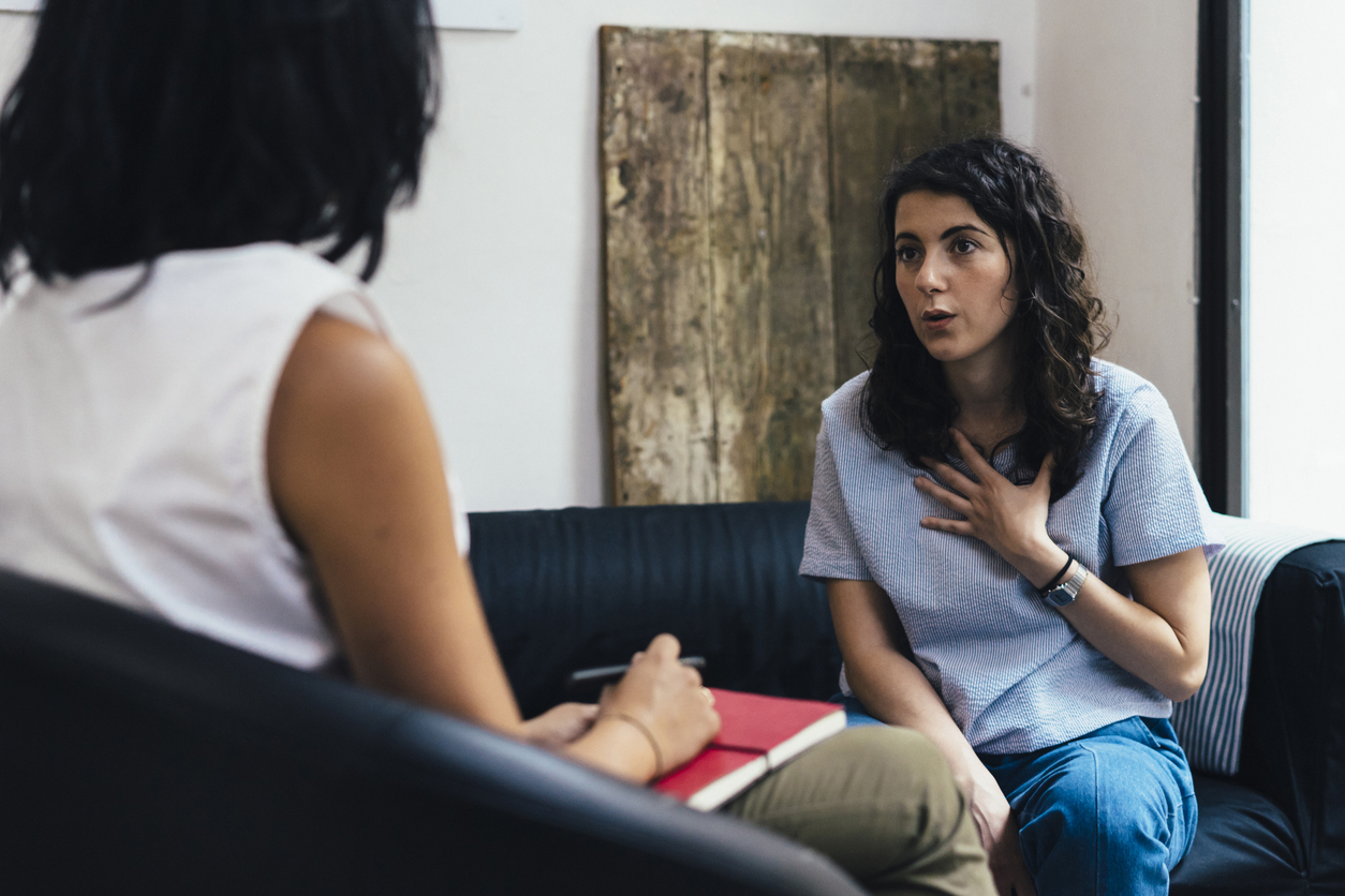 A Psychologist Listens to a Client in a Therapy Session.