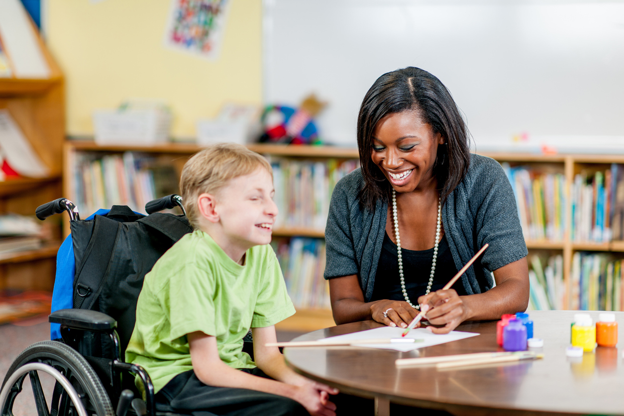 A Special Education Teacher Works With a Student in a Wheelchair