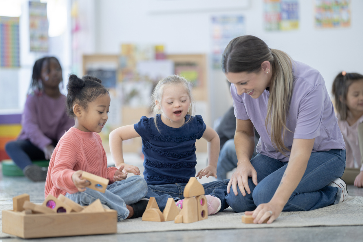 A Special Education Resource Teacher Helps Students Playing With Building Blocks