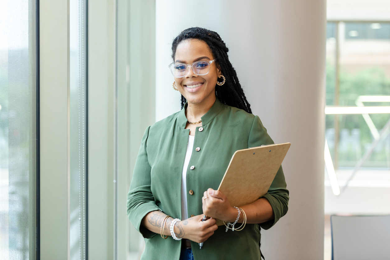 A Smiling Master of Education Student Holds a Clipboard..jpg