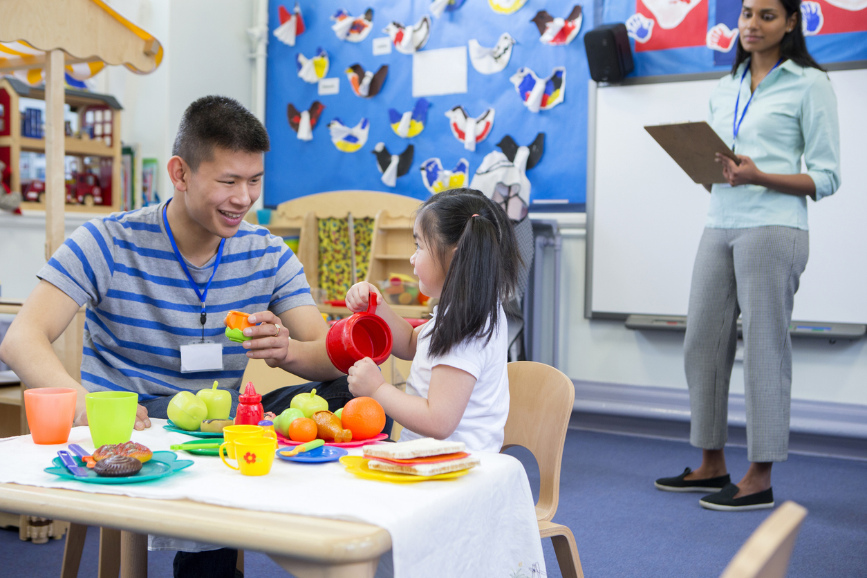 A Director of Childhood Education Observes a Preschool Teacher Working With a Student